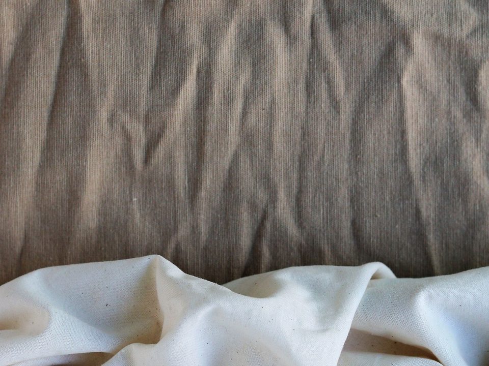 Close-up of layered cotton fabric in neutral tones