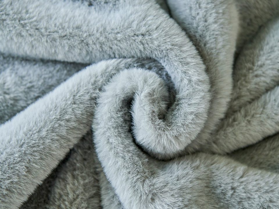 Close-up of soft grey fleece fabric rolled into a spiral
