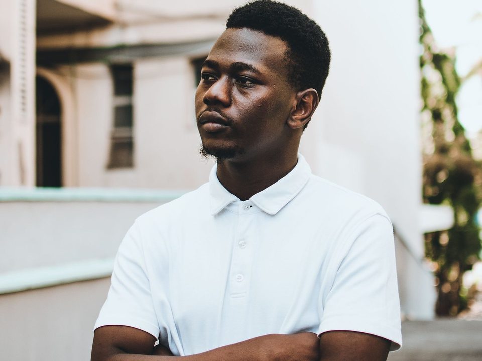 Model wearing a plain white short-sleeve polo shirt
