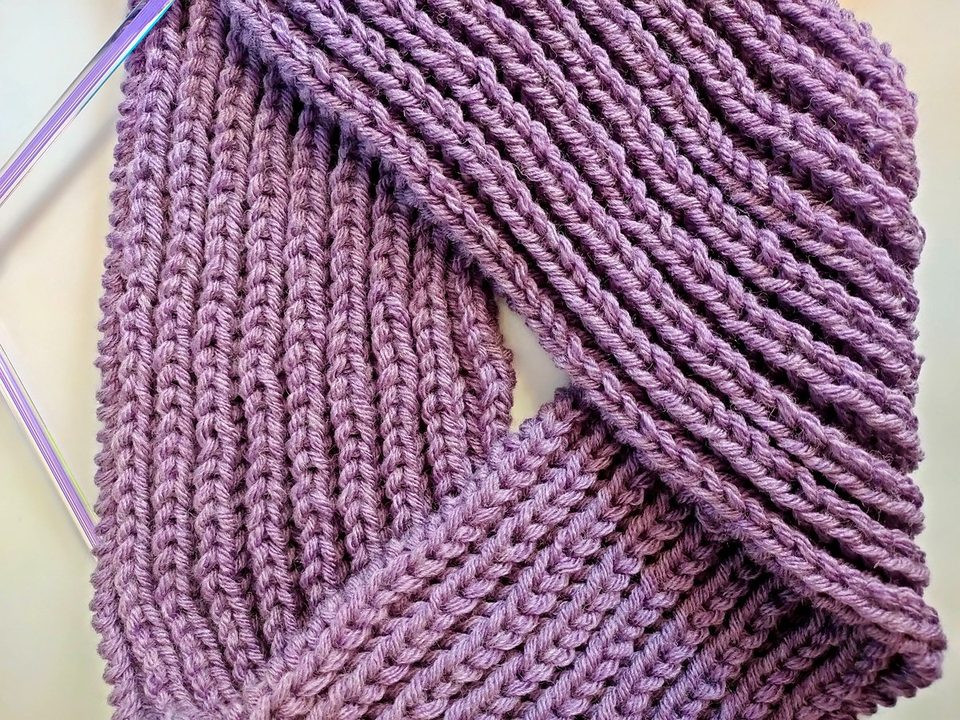 Close-up of purple rib-knit textile showing raised rows